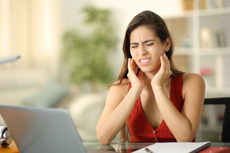 Physician explaining jaw joint anatomy to a patient with TMJ disorder